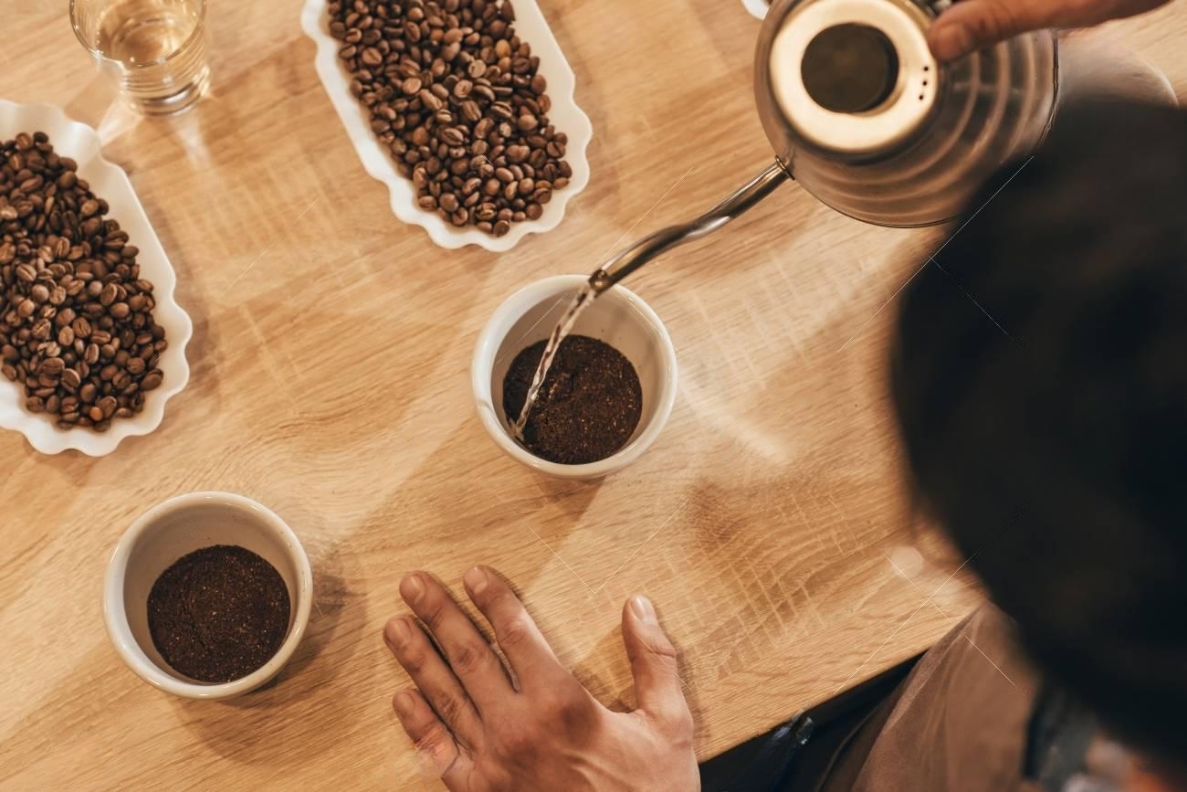 114541620-overhead-view-of-man-pouring-hot-water-into-bowl-with-grind-coffee-transformed